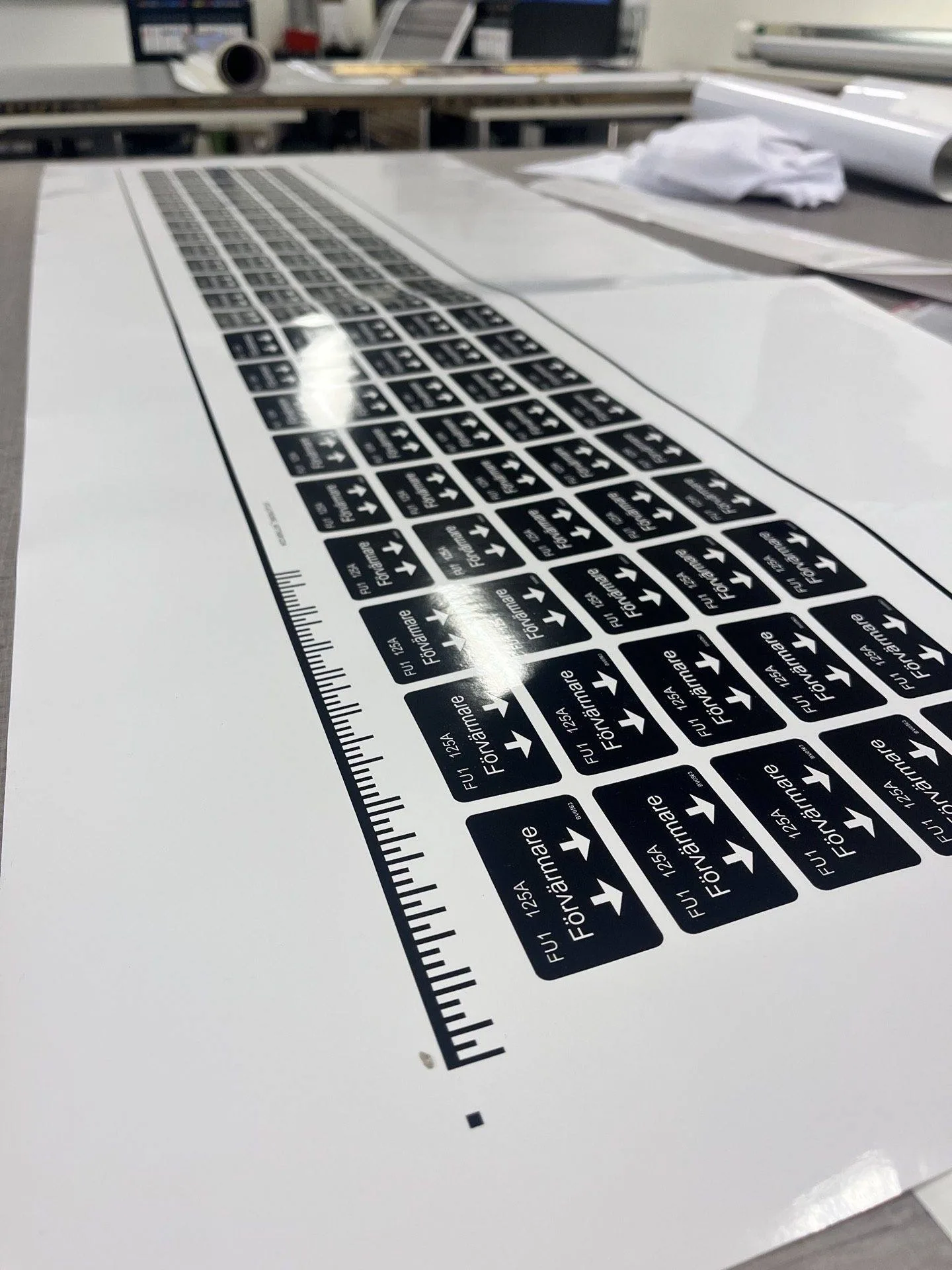 A printed layout of a keyboard with various labels and directional arrows, placed on a flat surface.